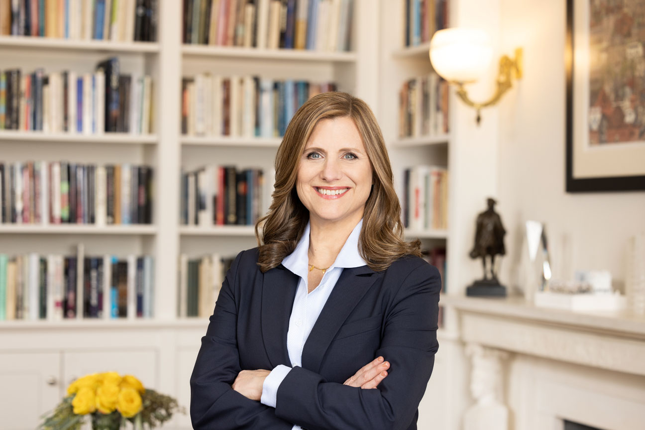 Official Portrait of Penn President M. Elizabeth Magill standing in her College Hall office.